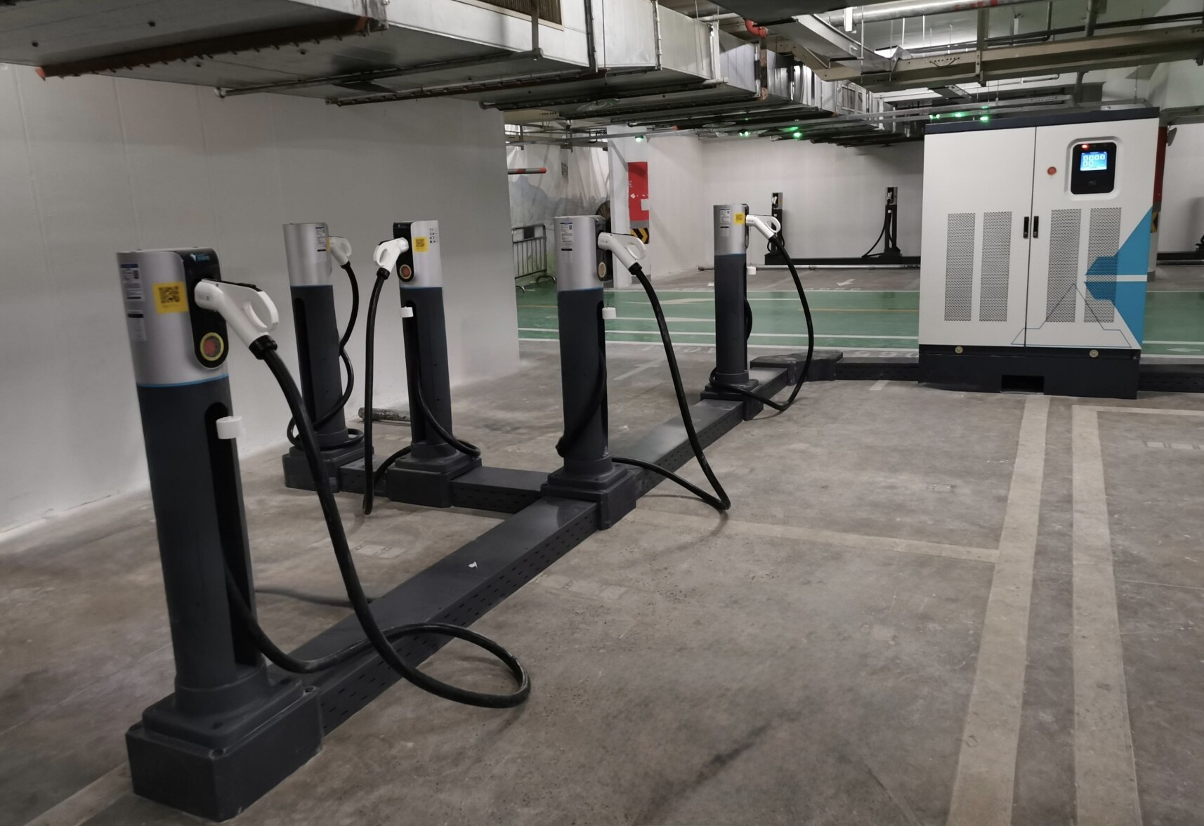 Row of Neutron rapid deployment EV charger dispensers in an indoor car park