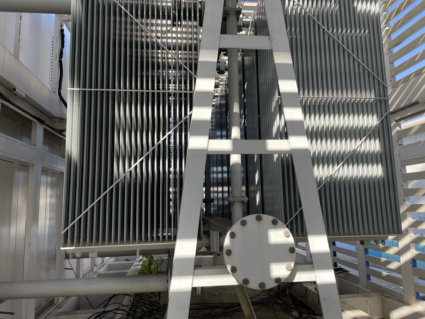 Large electric fleet depot with multiple charging bays and overhead infrastructure